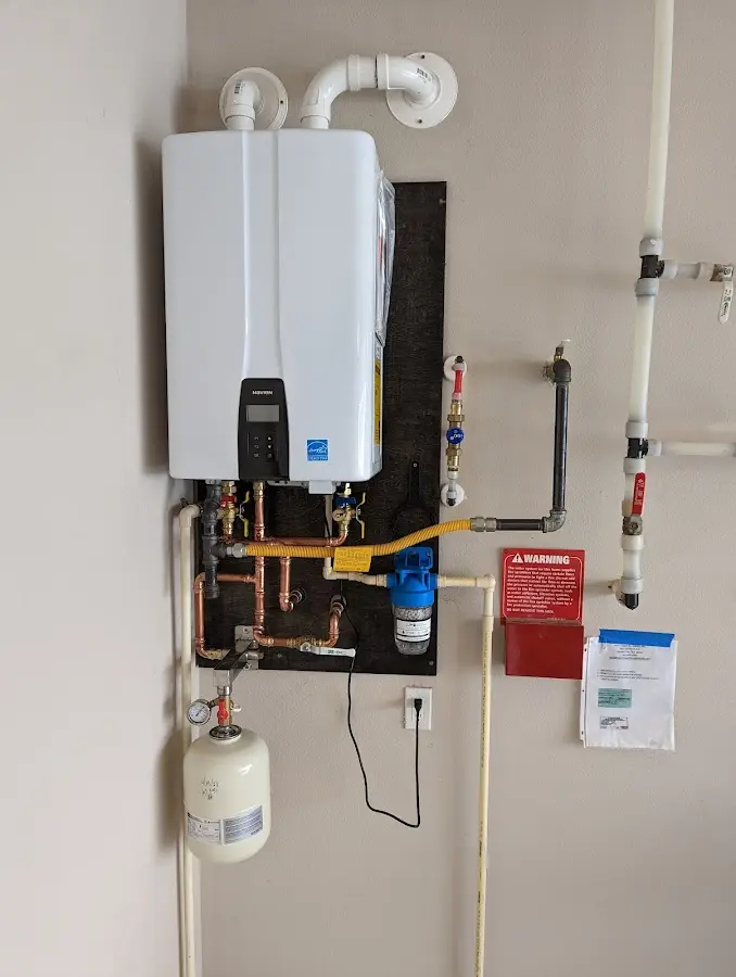 Professional plumber installing copper piping in a Lacy-Lakeview home